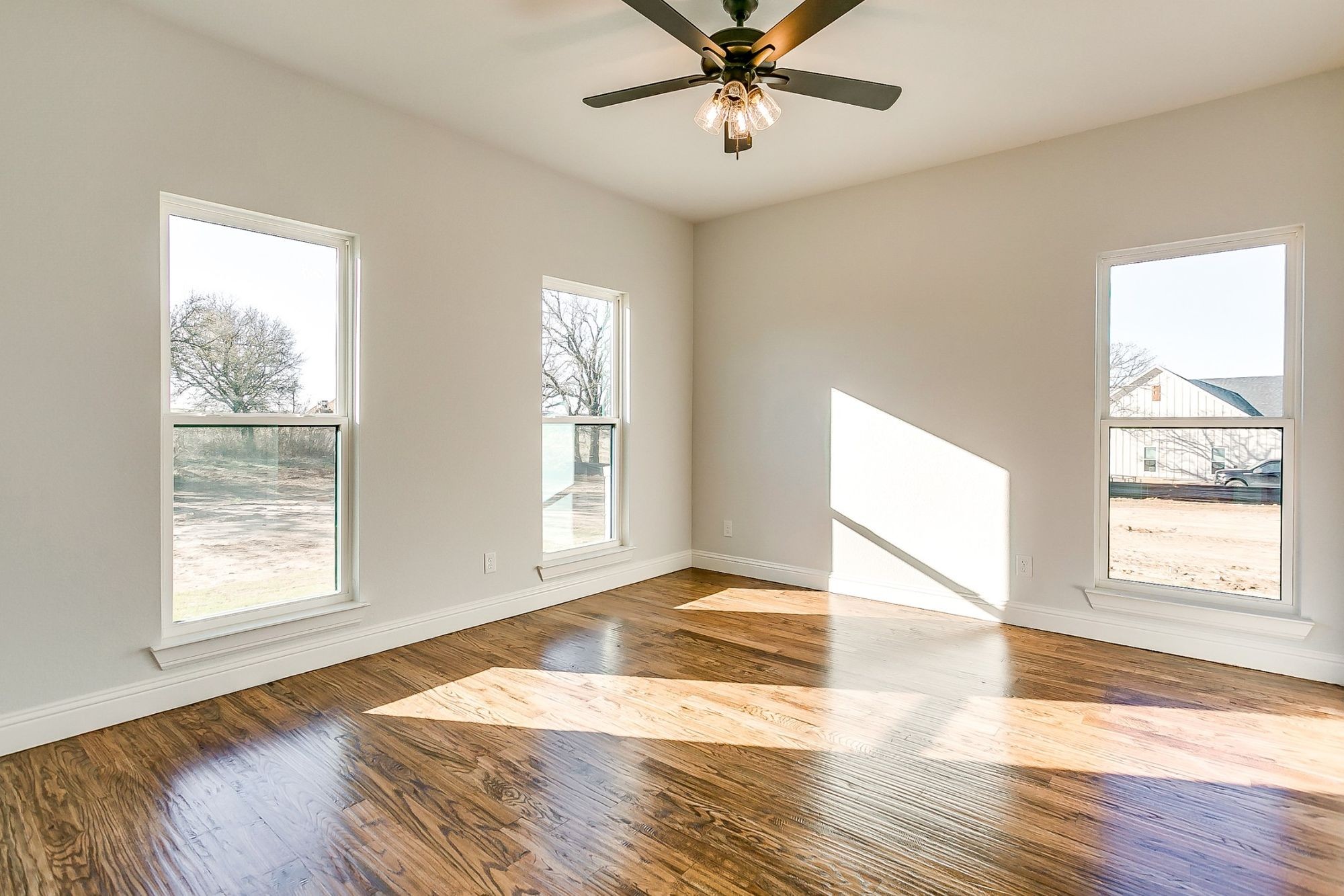 1526 Columbia Road Charlotte, TN 37036 - Photo 8 of 17 a view of an empty room with wooden floor and a window