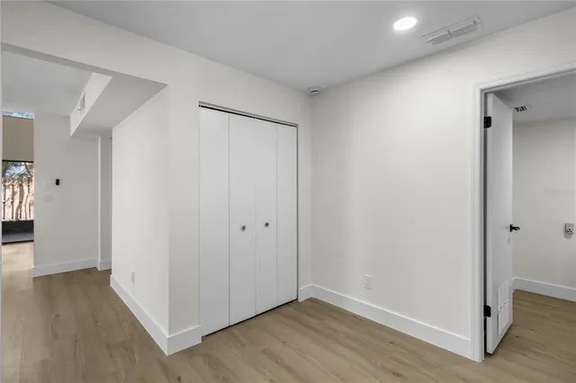 a view of an empty room with wooden floor