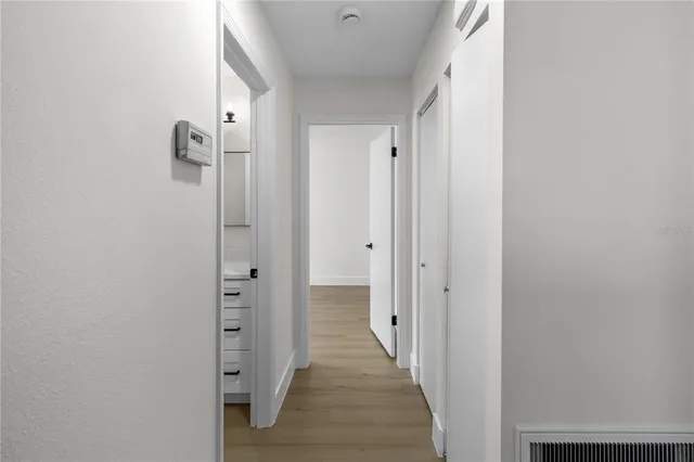 a view of a hallway with a wooden door