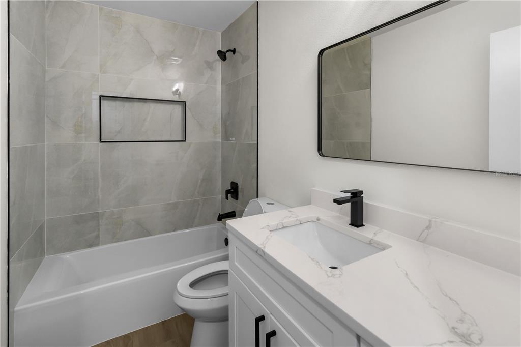 1888 Springbush Lane Clearwater, FL 33763 - Photo 25 of 31 a bathroom with a sink a toilet and a bathtub