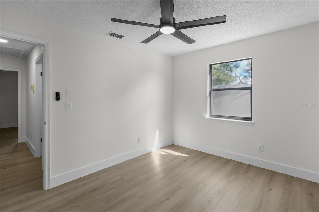 1888 Springbush Lane Clearwater, FL 33763 - Photo 27 of 31 an empty room with wooden floor and windows