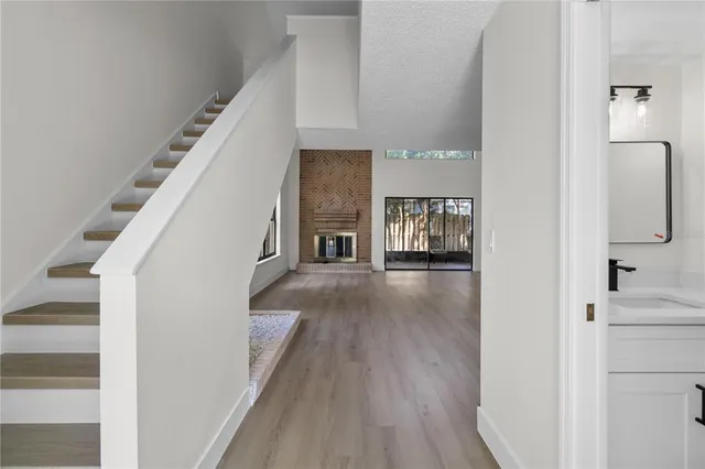a view of a hallway view with wooden floor and staircase