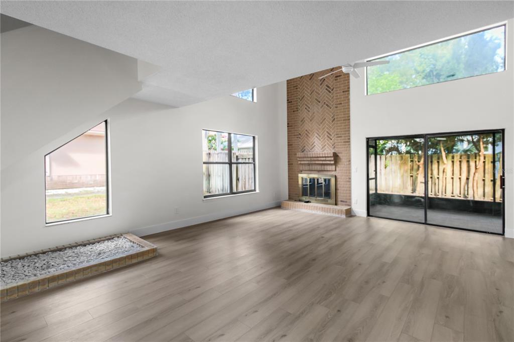 1888 Springbush Lane Clearwater, FL 33763 - Photo 6 of 31 an empty room with wooden floor and windows