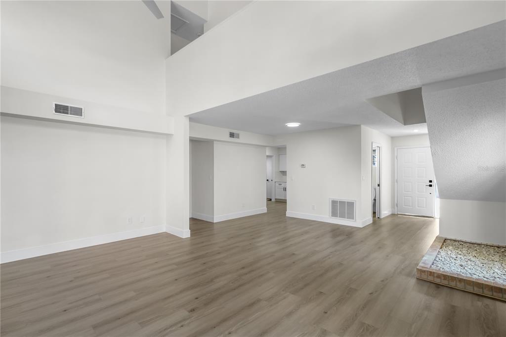 1888 Springbush Lane Clearwater, FL 33763 - Photo 8 of 31 a view of an empty room with wooden floor and a window