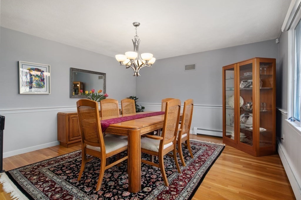 6 Dudley Road Lexington, MA 02421 - Photo 8 of 37 a dining room with wooden floor and a chandelier