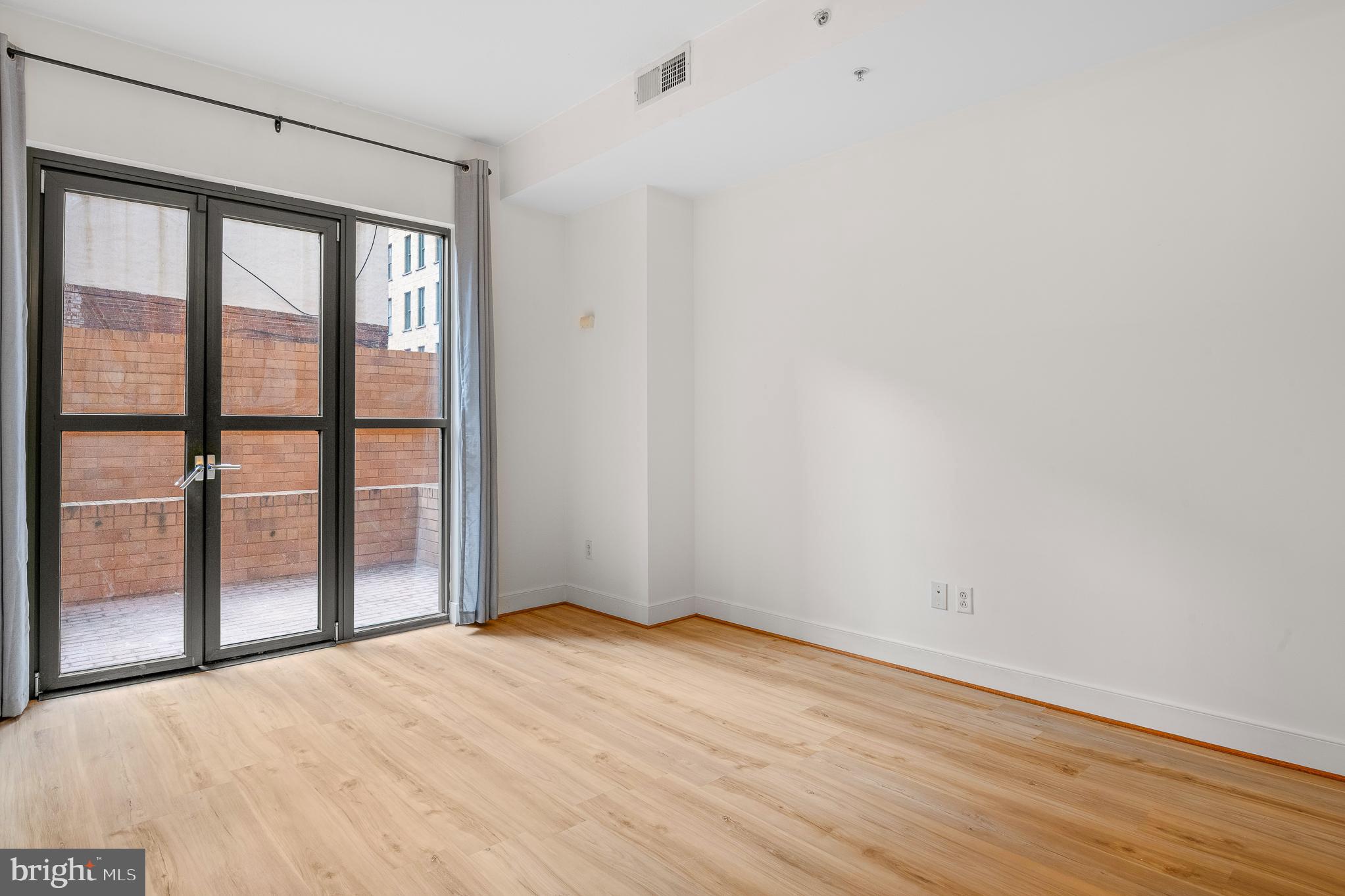 910 M Street Northwest, Unit 126 Washington, DC 20001 - Photo 18 of 54 a view of empty room with wooden floor and fan