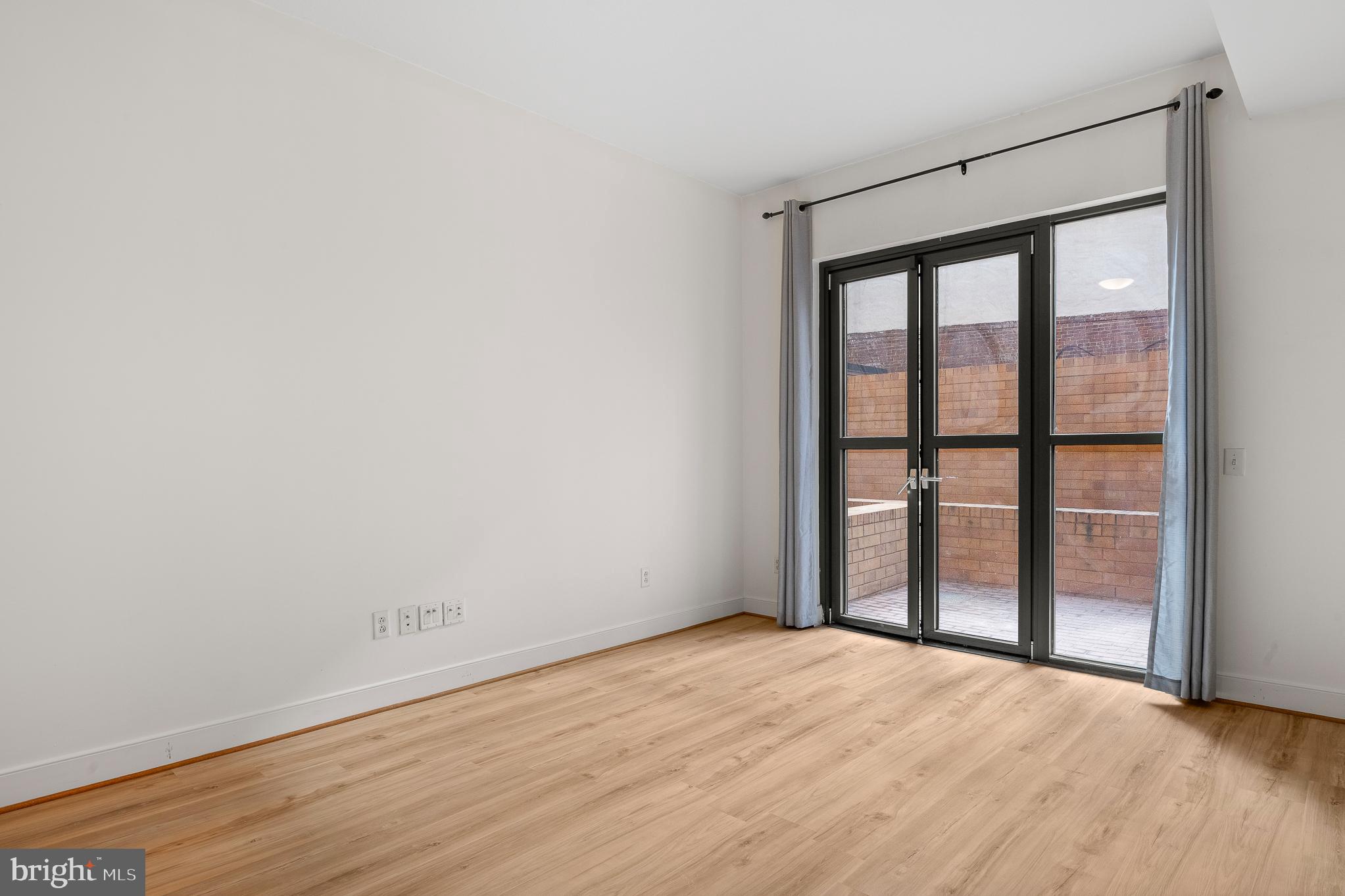 910 M Street Northwest, Unit 126 Washington, DC 20001 - Photo 19 of 54 a view of empty room with wooden floor and fan