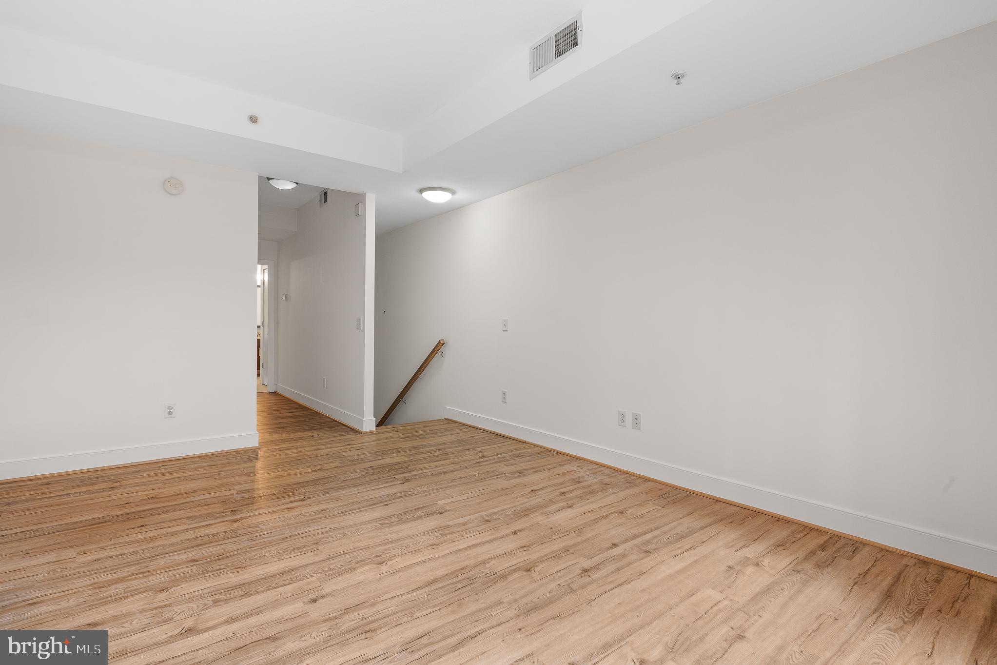 910 M Street Northwest, Unit 126 Washington, DC 20001 - Photo 24 of 54 a view of an empty room with wooden floor
