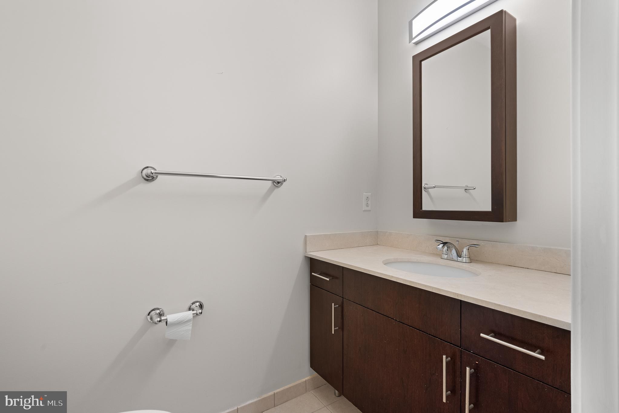 910 M Street Northwest, Unit 126 Washington, DC 20001 - Photo 34 of 54 a bathroom with a sink and a mirror