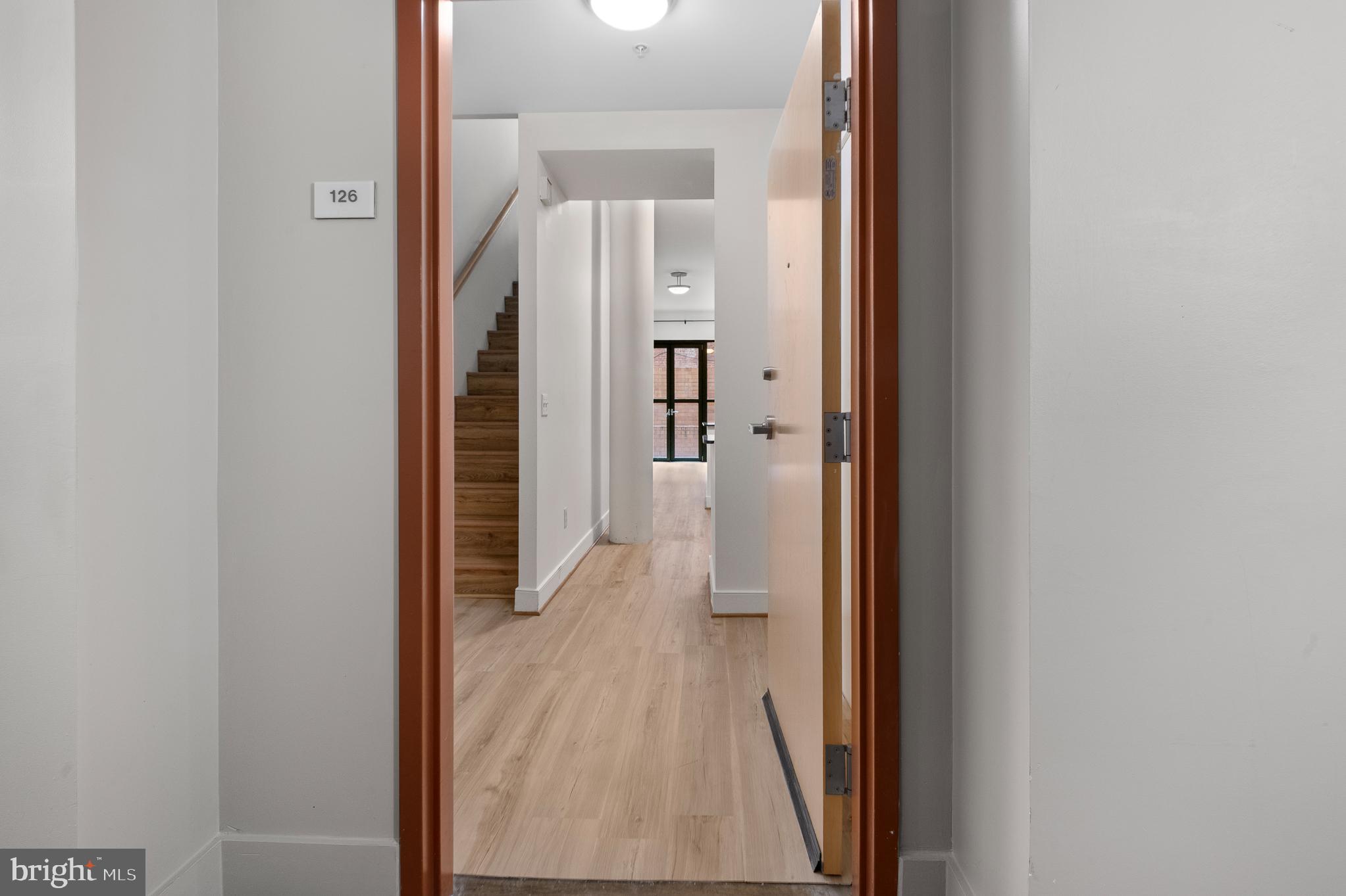 910 M Street Northwest, Unit 126 Washington, DC 20001 - Photo 8 of 54 a view of a hallway with wooden floor and staircase