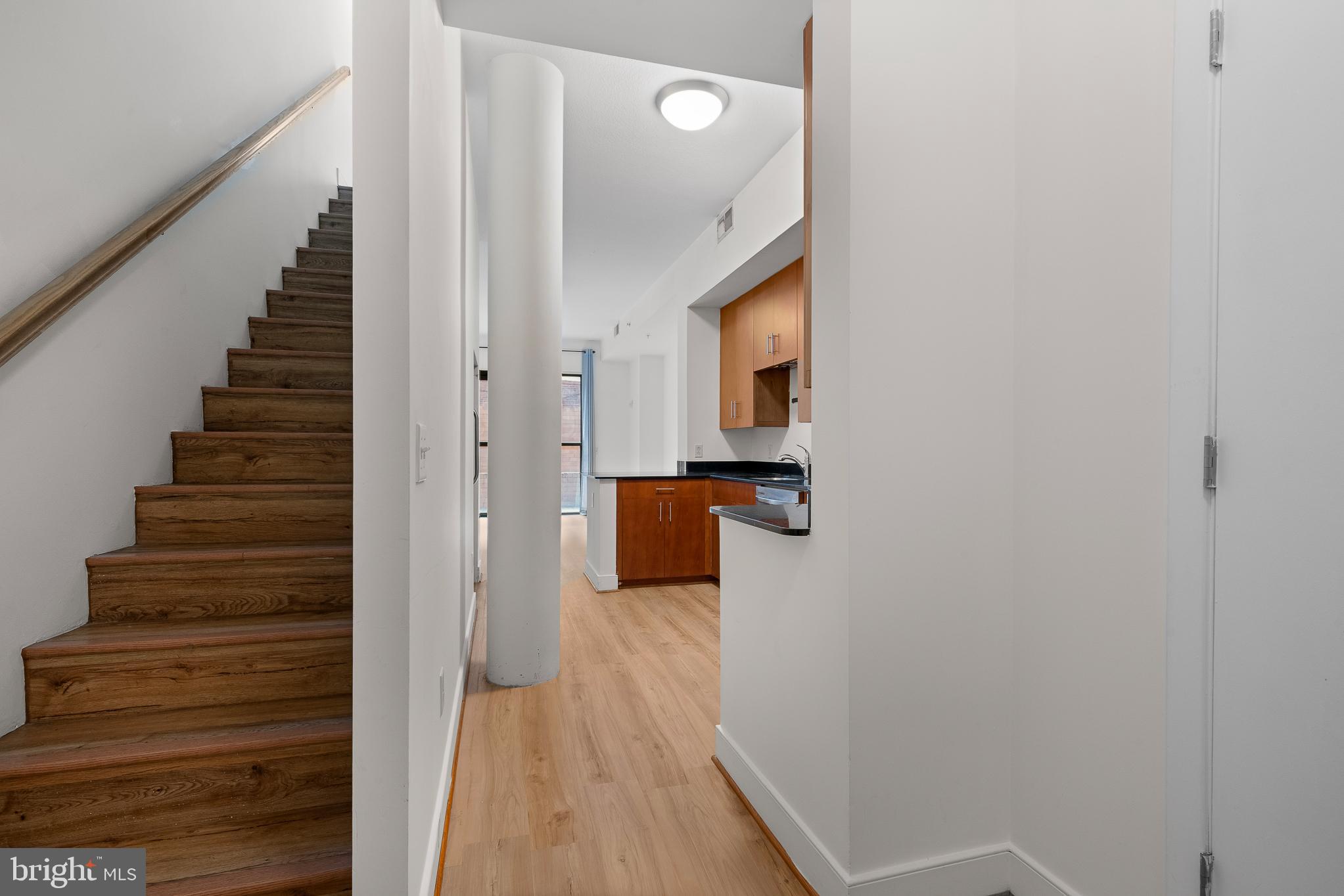 910 M Street Northwest, Unit 126 Washington, DC 20001 - Photo 9 of 54 a view of a hallway with wooden floor and staircase