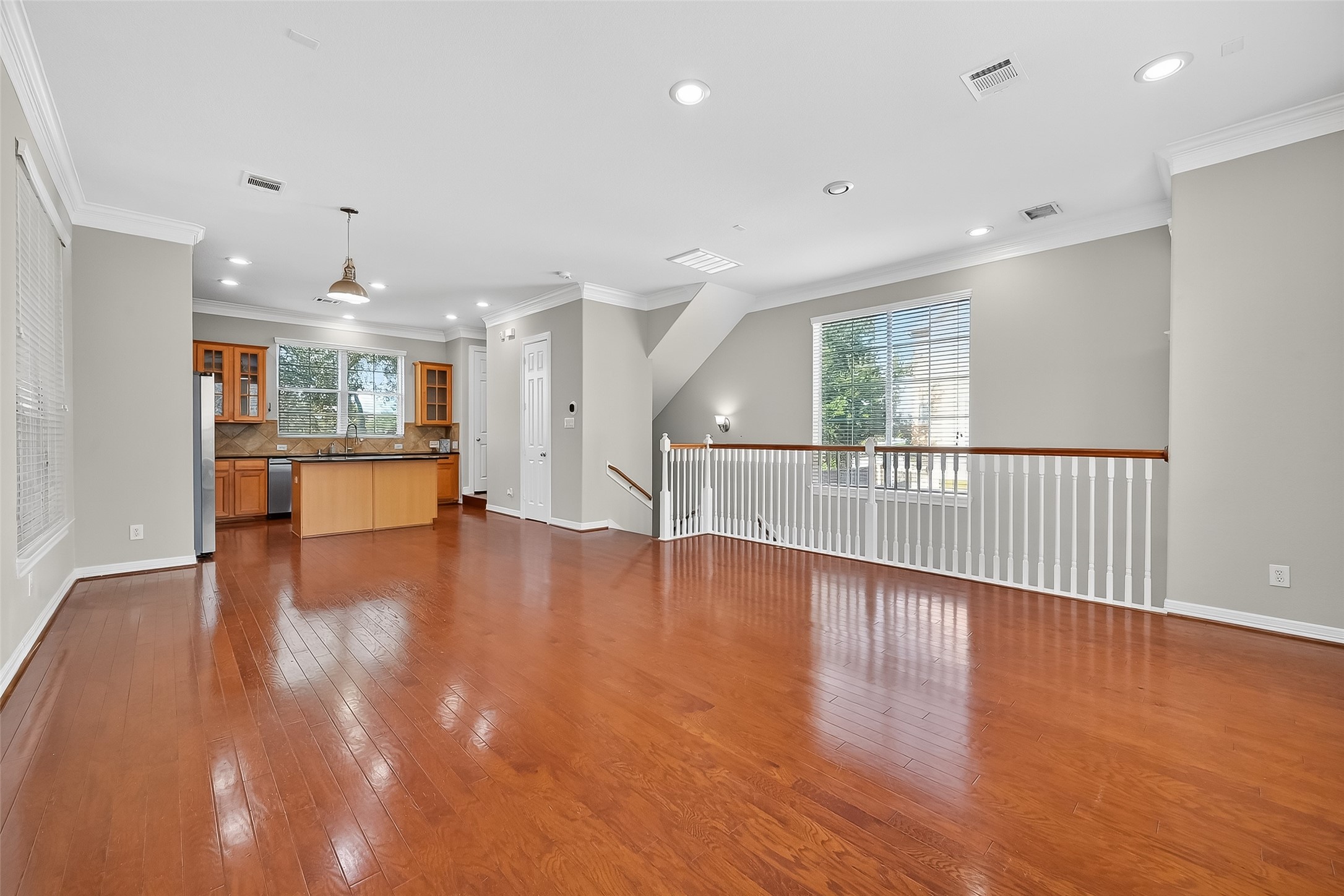 3019 Clearview Circle Houston, TX 77025 - Photo 11 of 42 a view of an empty room with wooden floor and a kitchen