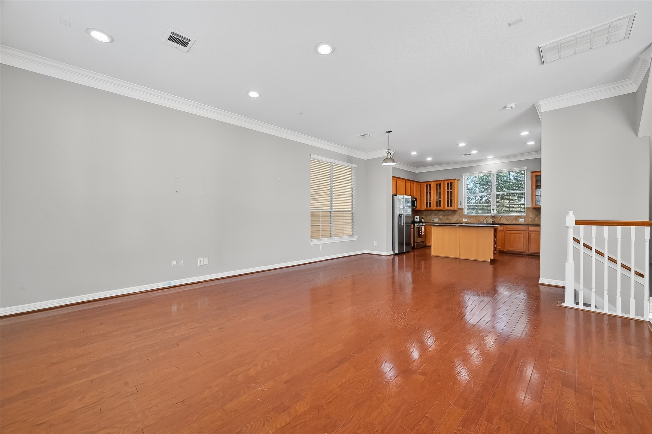 3019 Clearview Circle Houston, TX 77025 - Photo 13 of 42 a view of empty room with wooden floor and kitchen