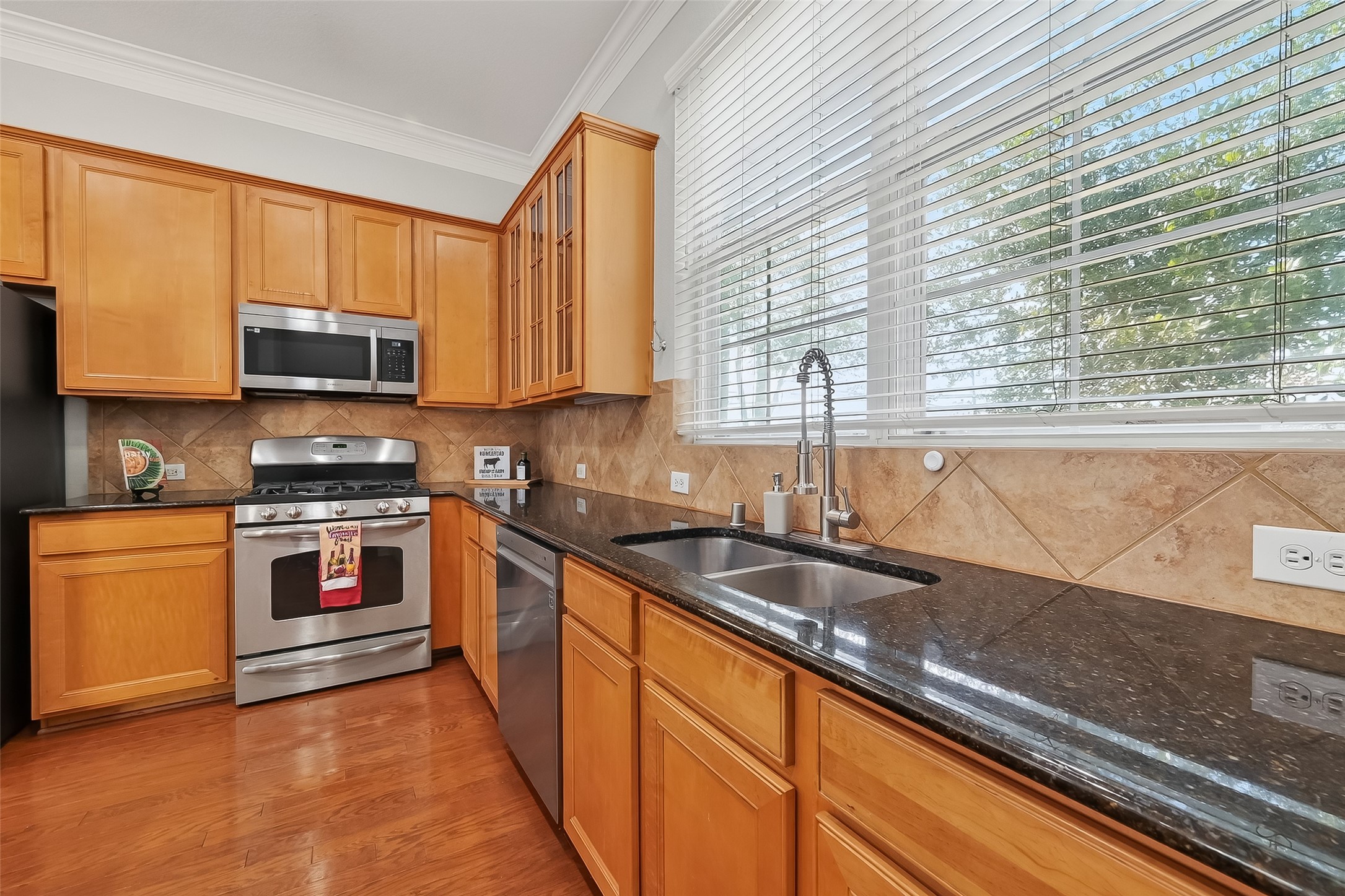 3019 Clearview Circle Houston, TX 77025 - Photo 16 of 42 a kitchen with granite countertop a stove and a sink