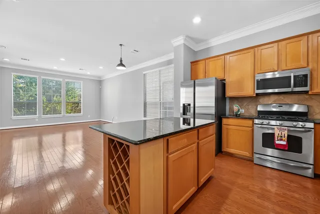 a kitchen with stainless steel appliances granite countertop a stove and a refrigerator