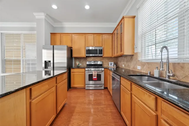 a kitchen with stainless steel appliances a stove sink and cabinets