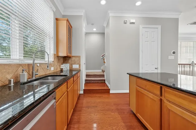 a kitchen with granite countertop a sink and a stove