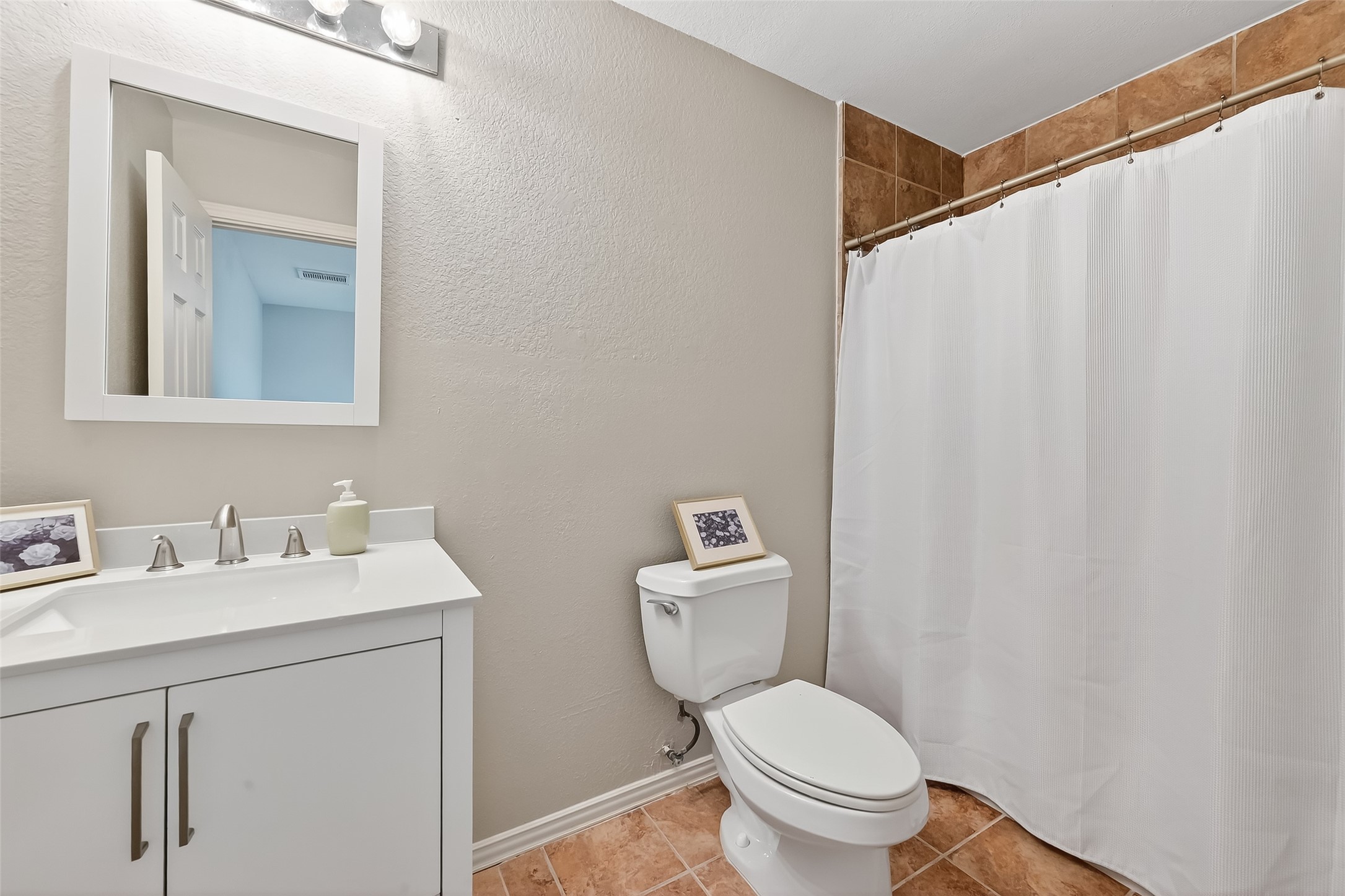 3019 Clearview Circle Houston, TX 77025 - Photo 32 of 42 a bathroom with a toilet a sink and a mirror