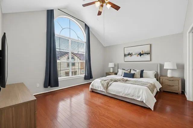 a bedroom with a bed and a large window