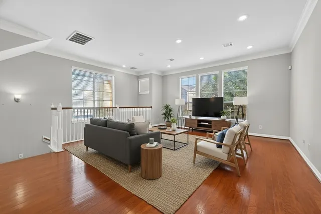 a living room with furniture flat screen tv and a fireplace