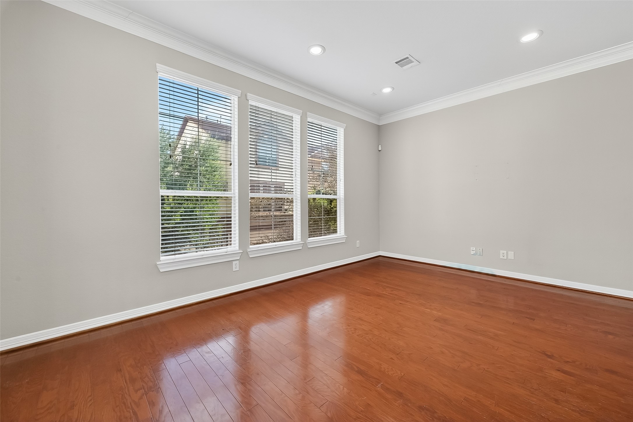 3019 Clearview Circle Houston, TX 77025 - Photo 7 of 42 an empty room with wooden floor and windows