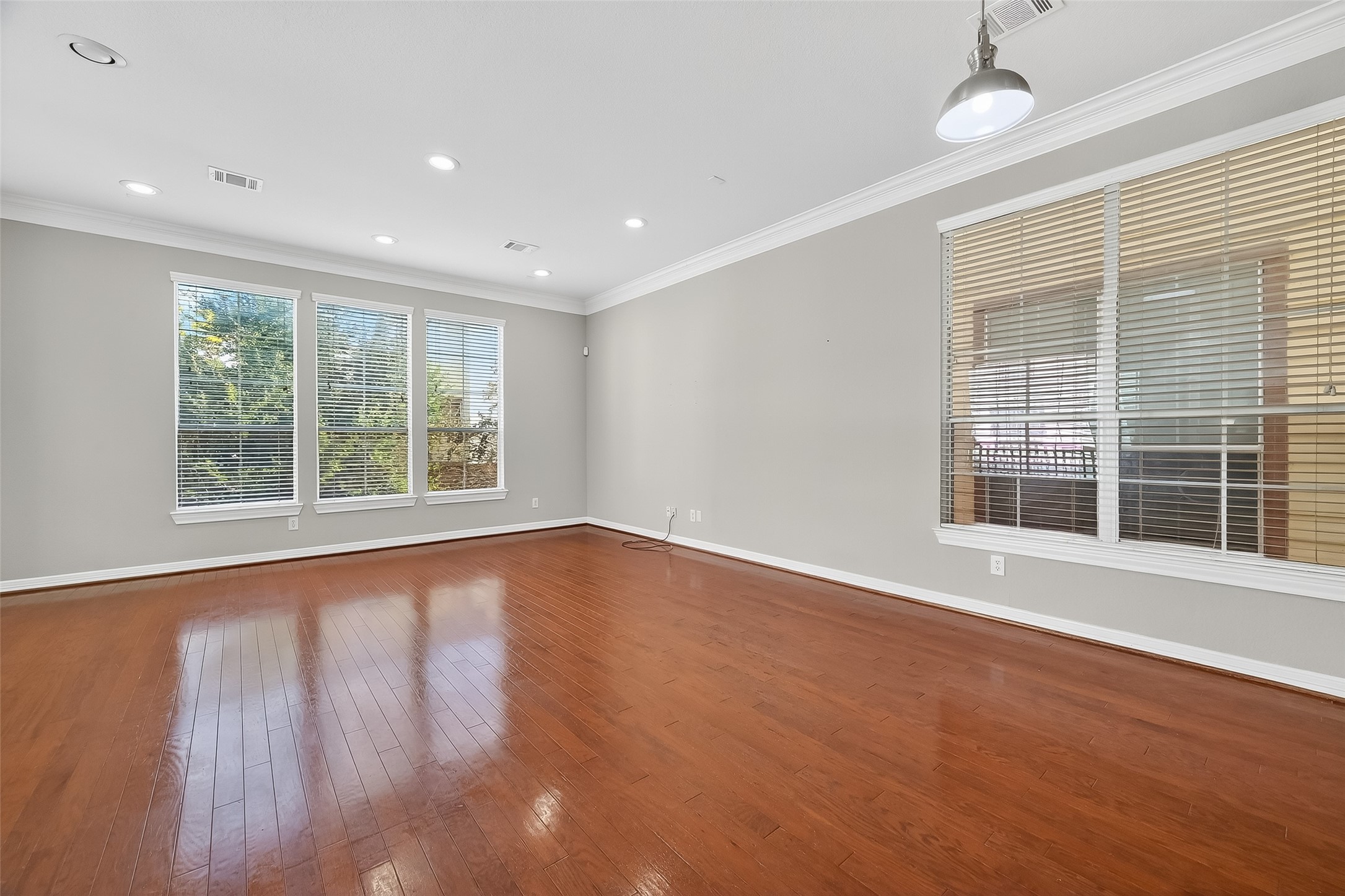 3019 Clearview Circle Houston, TX 77025 - Photo 8 of 42 a view of an empty room with wooden floor and a window