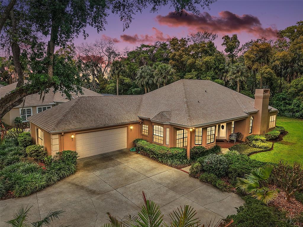 621 High Point Drive Mount Dora, FL 32757 - Photo 1 of 1 a aerial view of a house with a yard and a large tree
