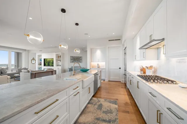 a large bedroom with a bed and wooden floor