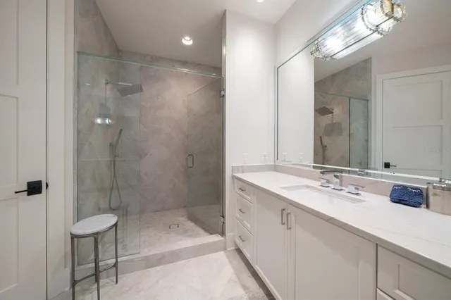 a kitchen with stainless steel appliances kitchen island granite countertop a table chairs sink and cabinets