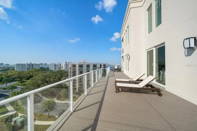 a bathroom with a granite countertop sink a toilet and a large mirror