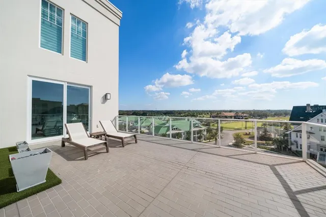 a large white bed sitting in a bedroom next to a large window