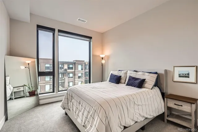 a bedroom with a large bed and a large window