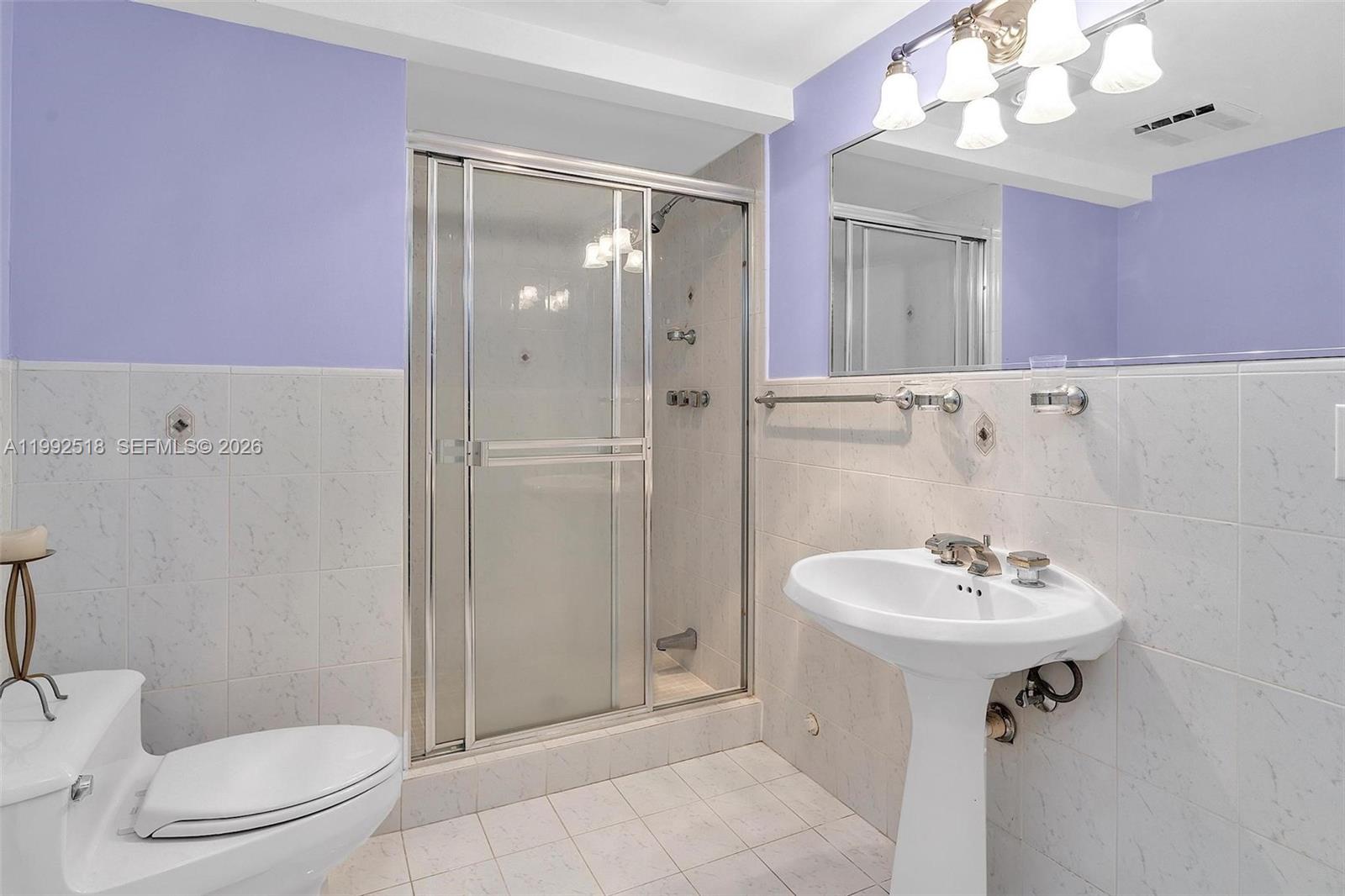 5309 Alton Road Miami Beach, FL 33140 - Photo 28 of 51 a bathroom with a sink a toilet and shower
