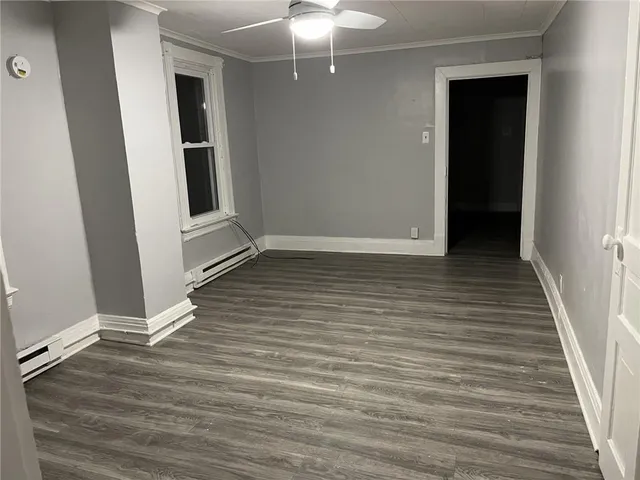 wooden floor in an empty room with a mirror