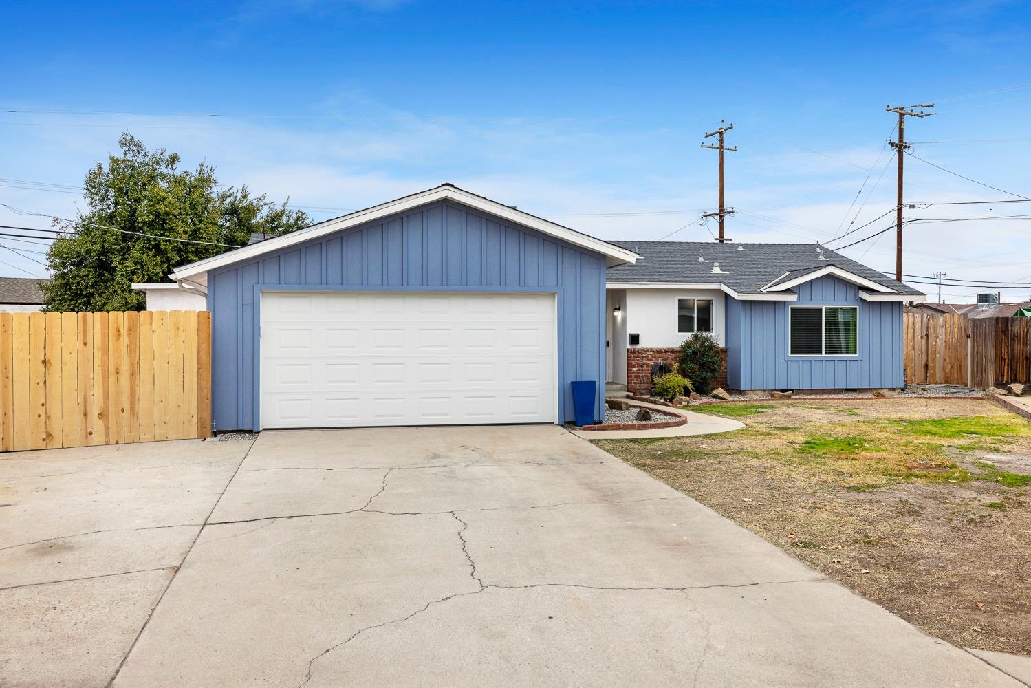 a view of a house with a backyard and garage