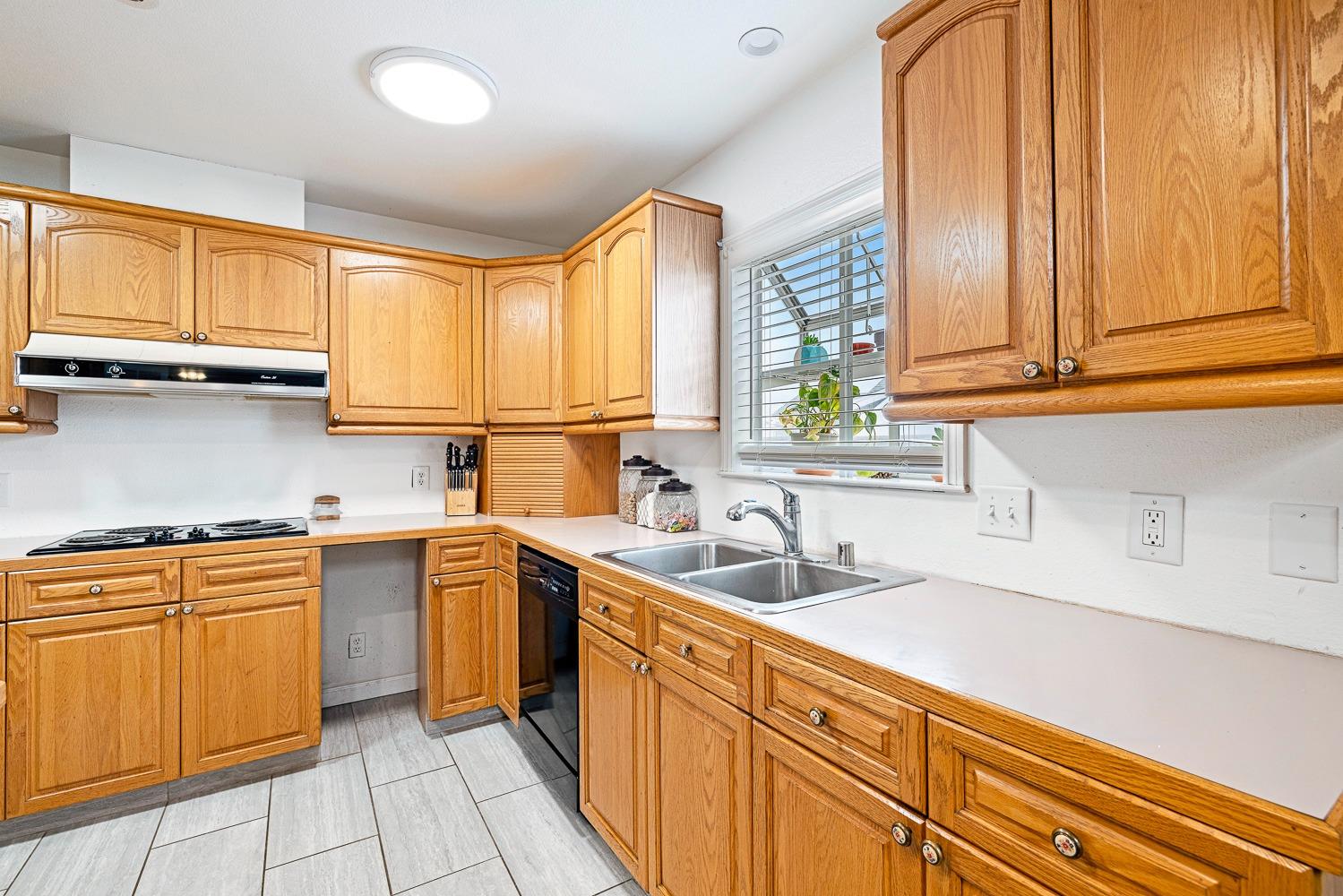 2637 Dewitt Avenue Clovis, CA 93612 - Photo 11 of 25 a kitchen with stainless steel appliances a sink window and cabinets