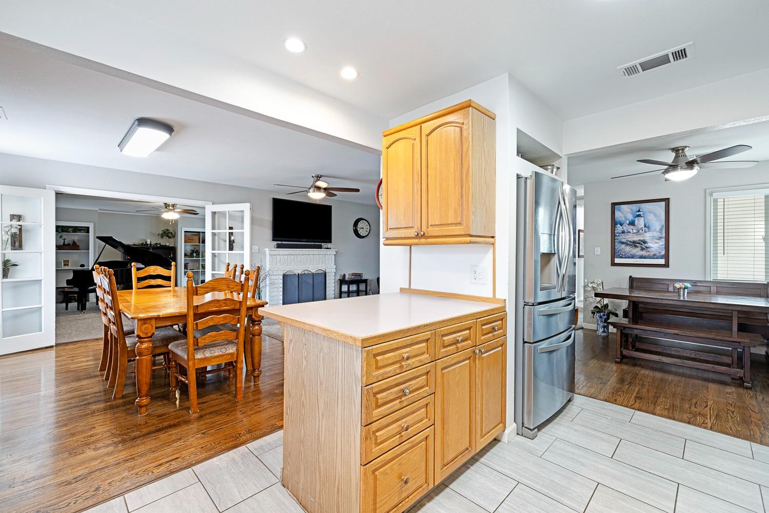 2637 Dewitt Avenue Clovis, CA 93612 - Photo 13 of 25 a kitchen with stainless steel appliances kitchen island granite countertop a refrigerator and cabinets