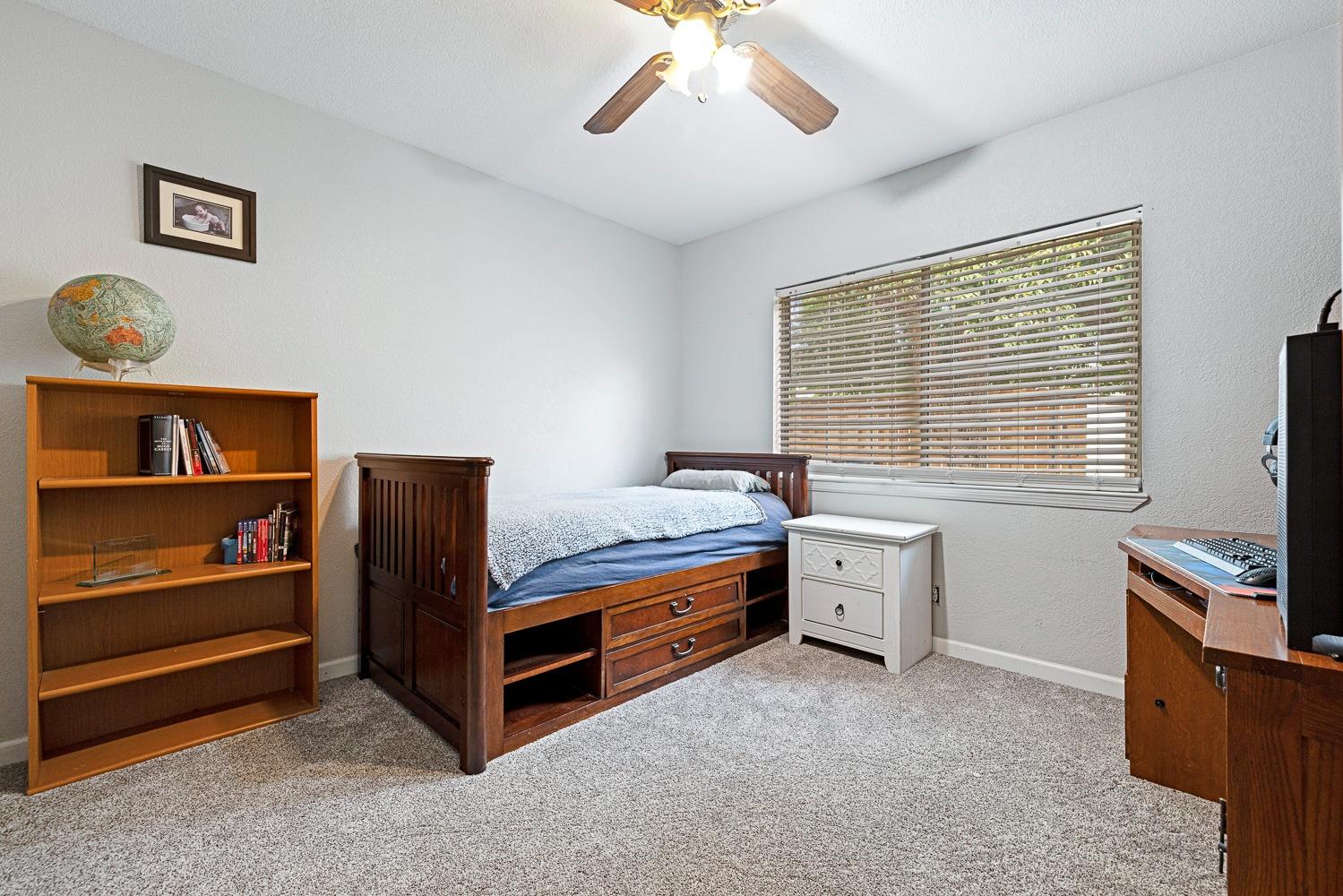 2637 Dewitt Avenue Clovis, CA 93612 - Photo 18 of 25 a bedroom with furniture and a flat screen tv