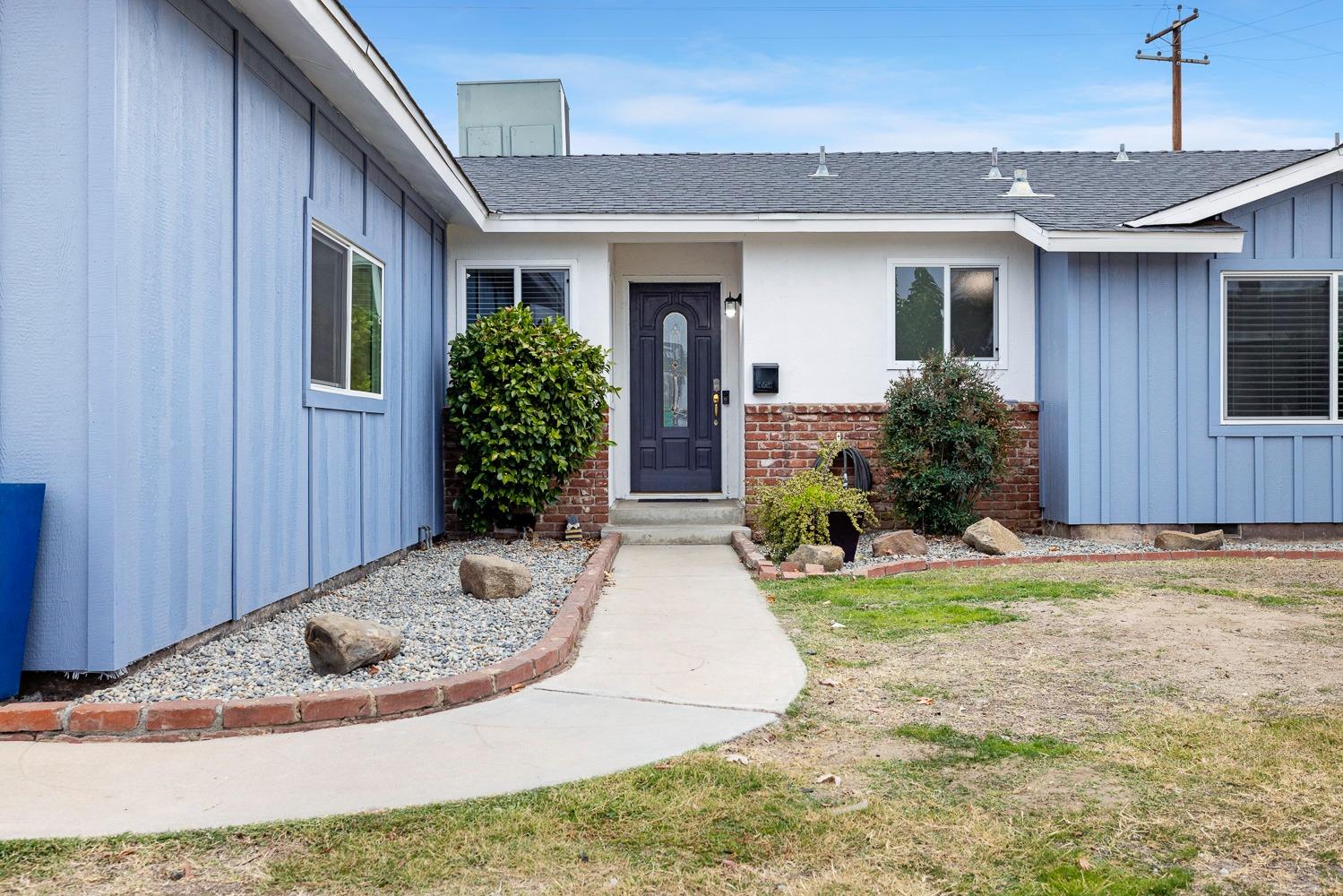 2637 Dewitt Avenue Clovis, CA 93612 - Photo 2 of 25 a view of a house with small yard plants and wooden fence