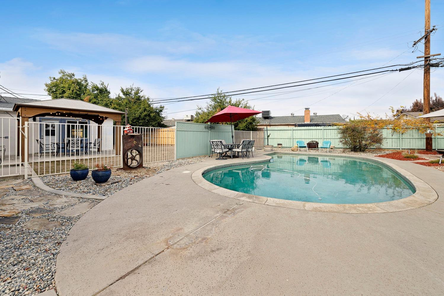 2637 Dewitt Avenue Clovis, CA 93612 - Photo 3 of 25 a view of a house with a swimming pool and sitting area
