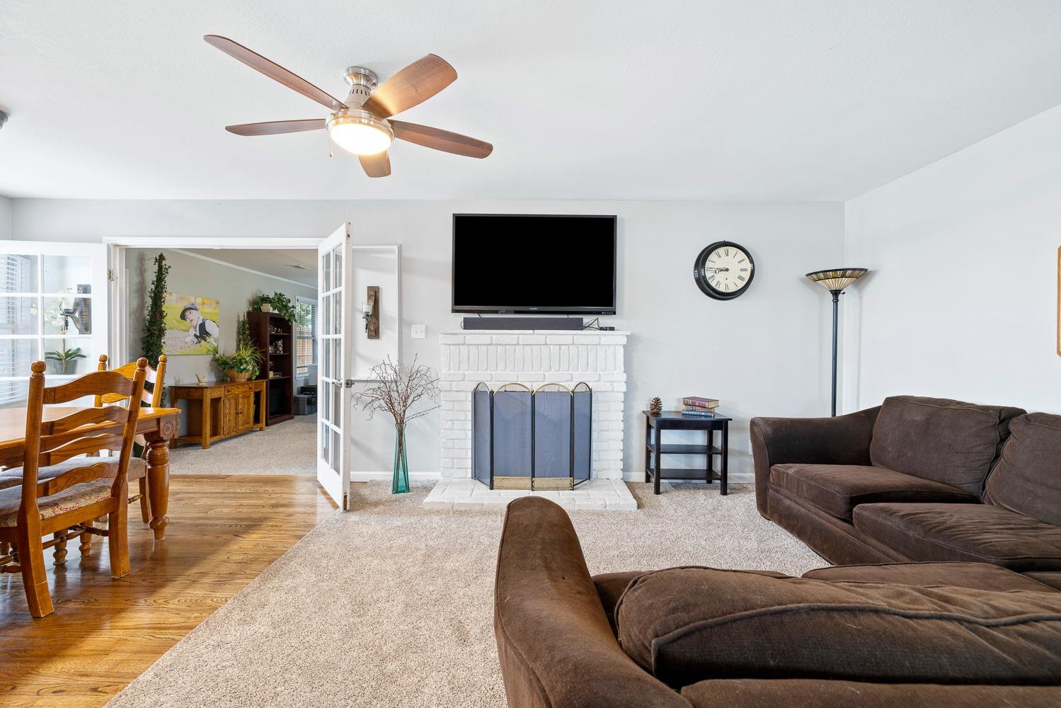 2637 Dewitt Avenue Clovis, CA 93612 - Photo 4 of 25 a living room with furniture a flat screen tv and a fireplace