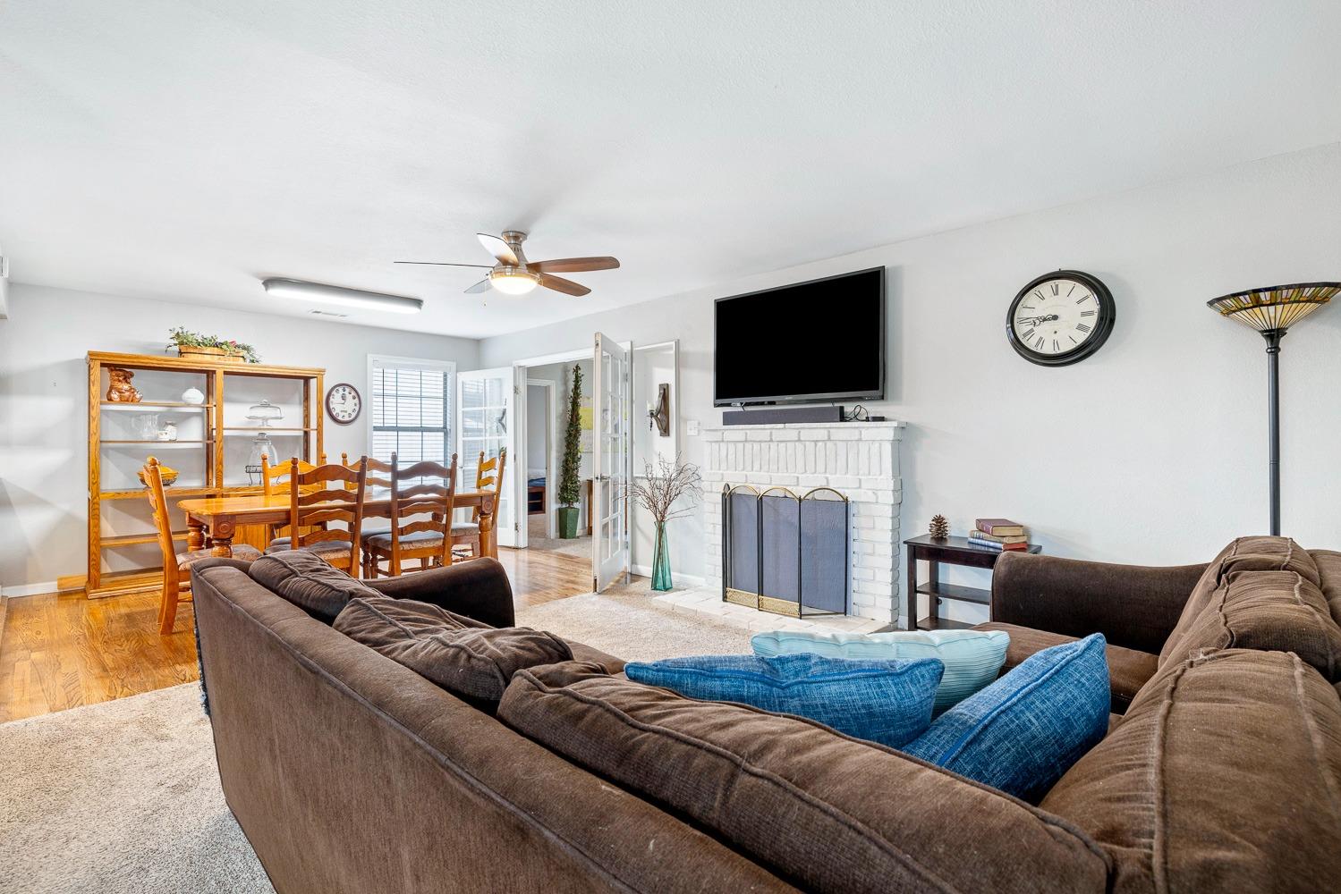 2637 Dewitt Avenue Clovis, CA 93612 - Photo 5 of 25 a living room with furniture a flat screen tv and a fireplace