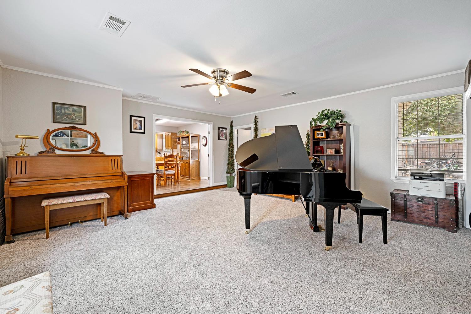 2637 Dewitt Avenue Clovis, CA 93612 - Photo 6 of 25 a living room with furniture piano and a window