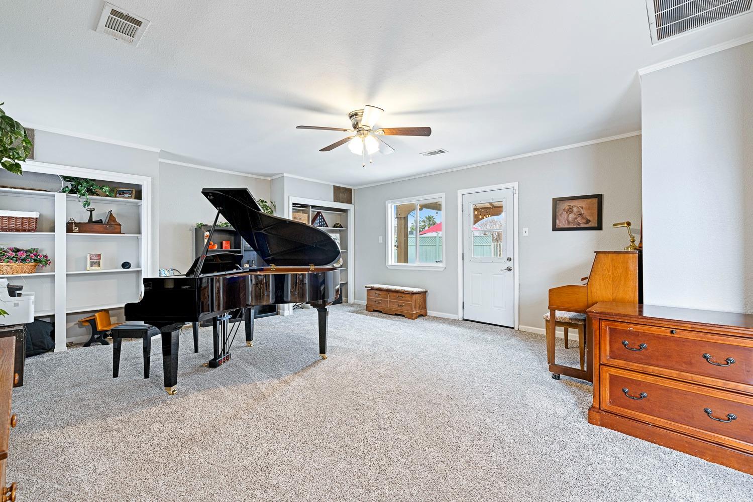2637 Dewitt Avenue Clovis, CA 93612 - Photo 7 of 25 a living room with furniture and a piano