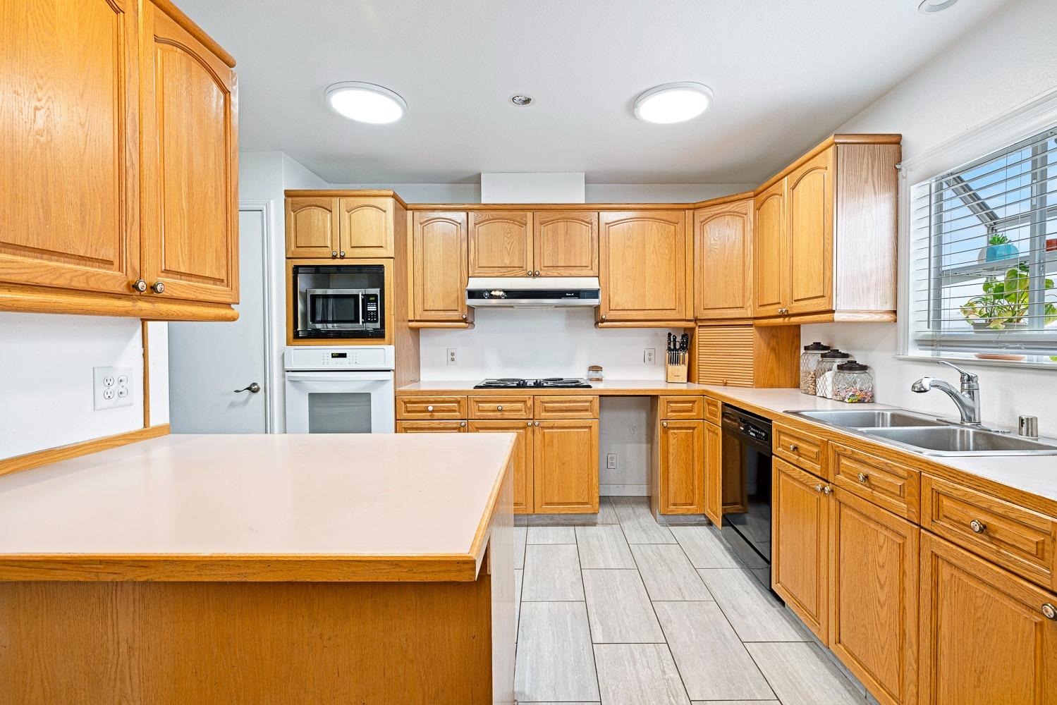 2637 Dewitt Avenue Clovis, CA 93612 - Photo 10 of 25 a kitchen with stainless steel appliances a stove sink and cabinets
