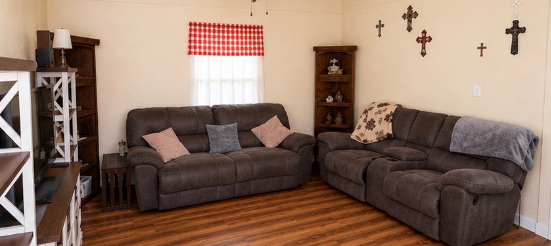 810 North 6th Street Temple, TX 76501 - Photo 4 of 9 Relax in this living room, featuring durable wood flooring and ample space for comfortable seating.