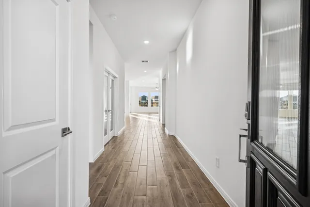 a view of hallway with wooden floor