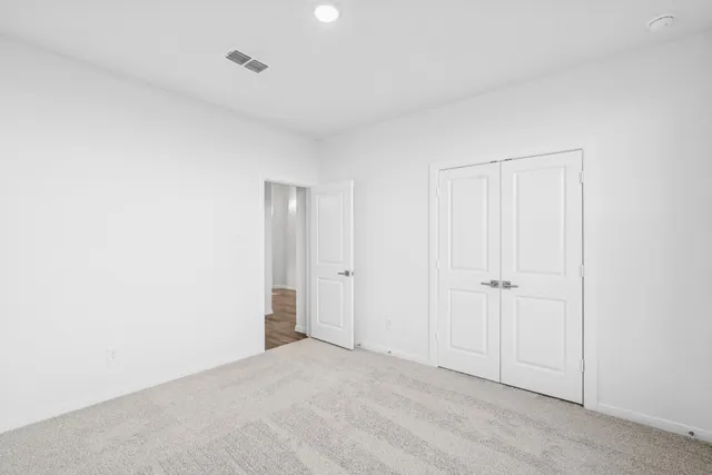 a bathroom with a granite countertop sink toilet a mirror and shower