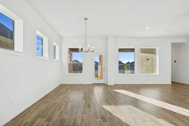 a view of an empty room with window and cabinet