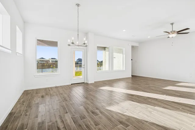 a view of a kitchen with wooden floor and a sink
